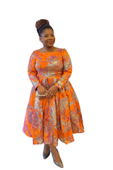 Woman wearing African Floral Brocade midi dress with cream base and olive floral patterns